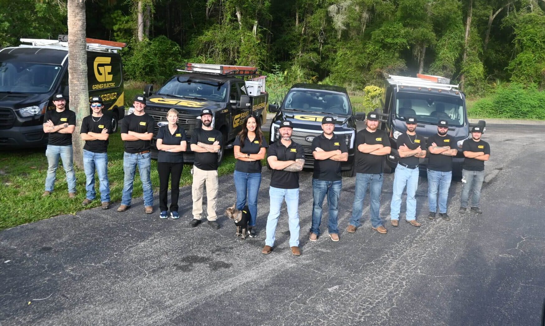 Grener Electric team of licensed electricians standing in front of company work trucks in Gainesville, FL